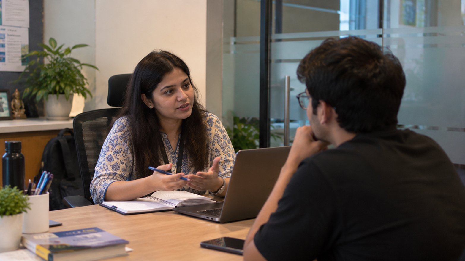 MBA admission counsellor guiding a student across a desk